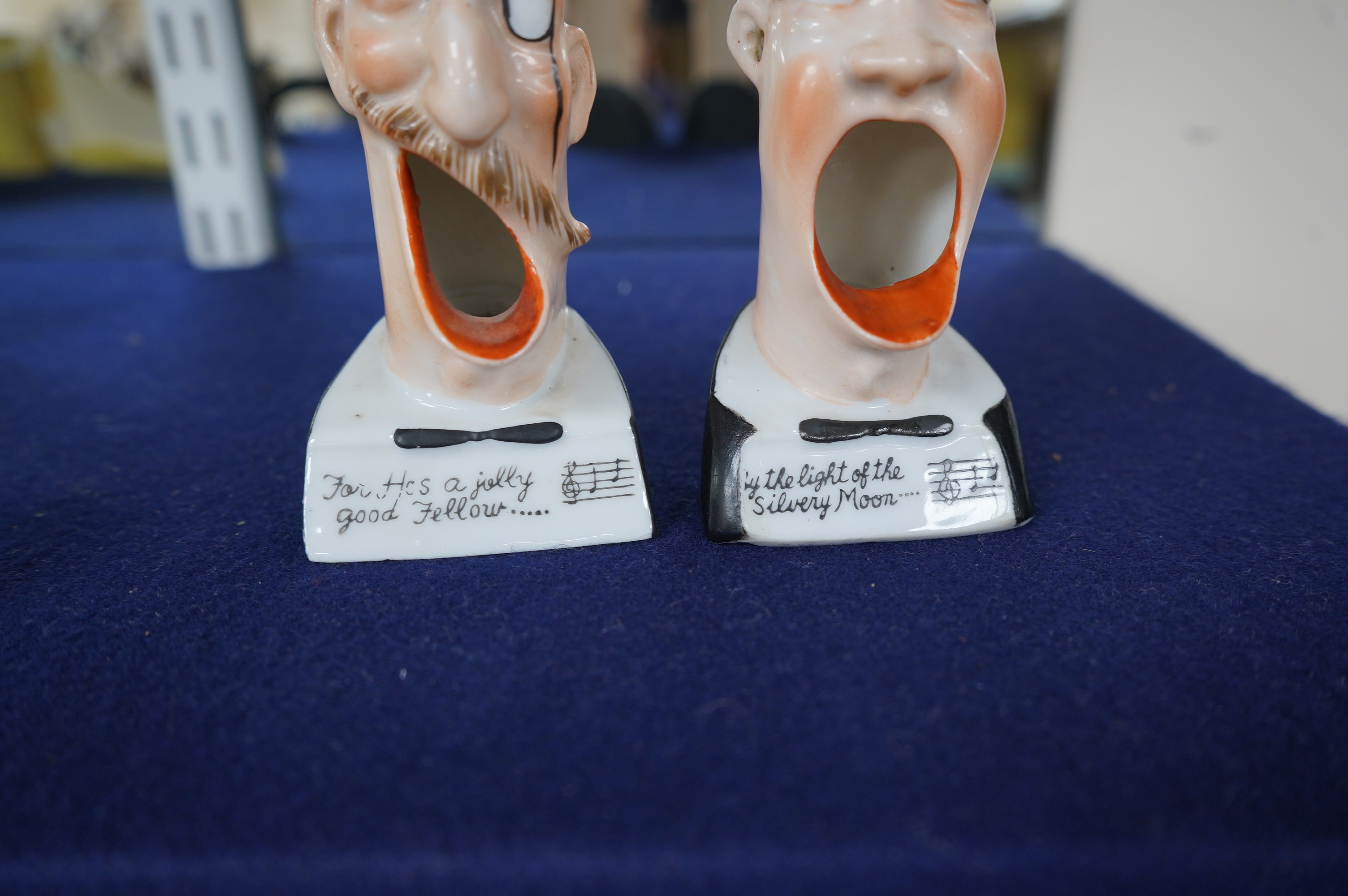 Two Vintage Schafer & Vater Ceramic Smoking Head ashtrays; 'He's A Jolly Good Fellow' and 'Light of the Silvery Moon', 13.5cm high. Condition - good